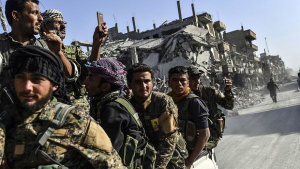 Kurdish fighters of the Syrian Democratic Forces (SDF) ride in the back of a truck in Raqa. (AFP/ File Photo)
