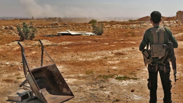 A Syrian rebel looks out to Idlib (AFP/FILE)