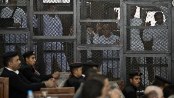 Detained Al Jazeera journalists on trial at an Egyptian court in January 2015.  The journalists, Australian Peter Greste, Egyptian-Canadian Mohammad Fahmy, and Egyptian Baher Mohammad, were held on charges including spreading false news and aiding a terrorist organization.  (AFP/Khaled Desouki)