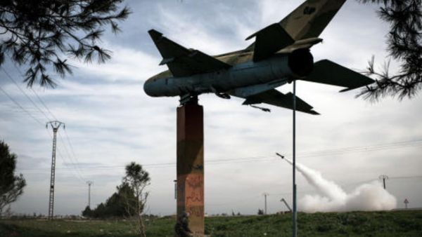 Syrian rebels fire a rocket towards regime forces stationed at Kwiriss airport in Al-Bab, 30 k from Aleppo, in this image from early 2013. [Getty]