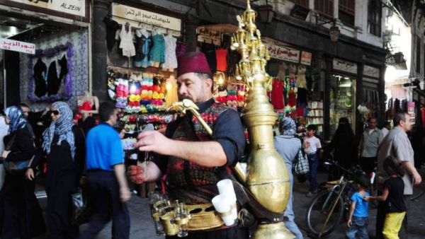 A man sells traditional drinks on the streets of central Damascus.  (AFP/File)