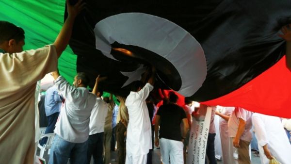 Tripoli residents display a flag at a rally in support of the Libya Dawn militia.  (AFP/File)