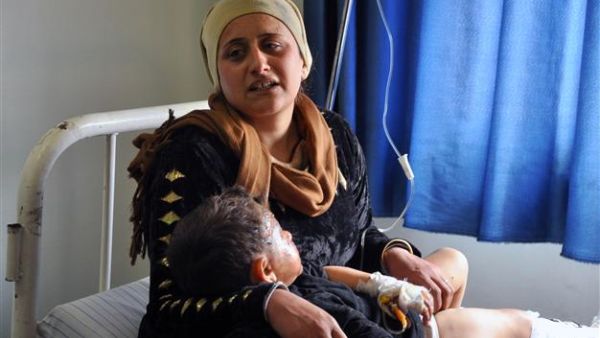 A Syrian Kurdish woman and child await treatment at a hospital in Syria's majority-Kurdish northeastern city of Qamishli following a bomb attack, March 21 2015.  (AFP/File)