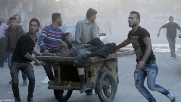 Two injured men are transported on a fruit barrow in the Syria, following a shelling. (Image credit: AFP)