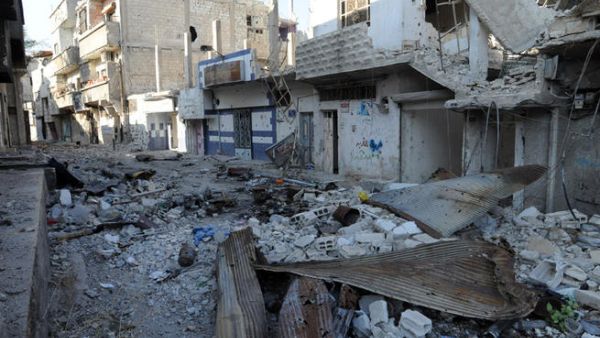 A picture taken on November 13, 2013 shows debris and damaged buildings in the town of Hujeira south of the Syrian capital Damascus. (Image credit: AFP)