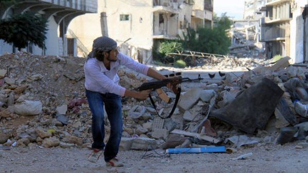 A rebel fires a gun in Syria. Women have appeared on Syrian television saying they were kidnapped by rebel forces for “sexual jihad.” (Image credit: AFP)