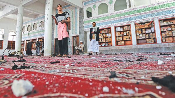 People inspect damage following a string of Daesh-claimed attacks in March on Shiite mosques in Yemen's capital Sanaa. Friday's attack injured 13, say security sources.  (AFP/File)