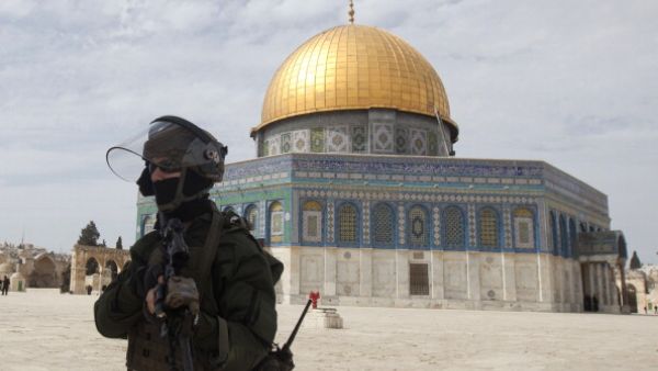 Israeli riot police walk at Jerusalem's al-Aqsa mosque compound during clashes with Palestinian demonstrators following Friday prayers on March 8, 2013. [Ahmad Gharbali/Getty Images]