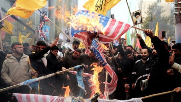 Iranians burn US flags outside the former US embassy in Tehran on November 4, 2013, during a demonstration to mark the 34th anniversary of the 1979 US embassy takeover. [Getty Images]