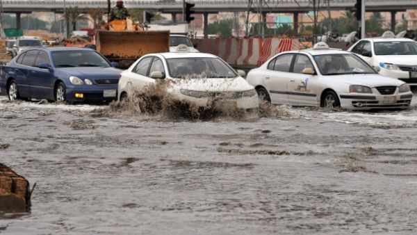 Cars drive through a flooded street in northern Riyadh, on November 17, 2013, after heavy rains fell overnight in the Saudi capital, caused floods and traffic jams. [FAYEZ NURELDINE/AFP/Getty Images]
