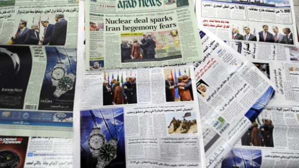 Saudi newspapers headlining the deal made with major powers over Iran's disputed nuclear deal are seen on November 25, 2013 in the capital Riyadh. [AFP]