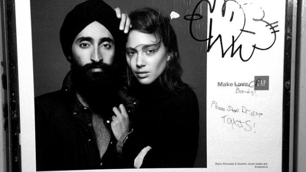 Anti-Muslim graffiti was found scribbled on a GAP ad featuring the Sikh jewelry designer and actor Waris Ahluwalia on a New York City subway platform. [Robert Gerhardt]


