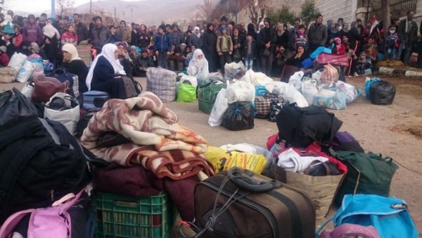 Syrians wait for the arrival of an aid convoy on January 11, 2016 in the besieged town of Madaya as part of a  deal reached in September for an end to hostilities in those areas in exchange for humanitarian assistance. (AFP/Stringer)