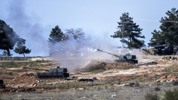 Turkish tanks stationed at a Turkish army position near the Oncupinar crossing close to the town of Kilis, south central Turkey, fire towards the Syria border, on February 16, 2016. (AFP/Bulent Kilic)