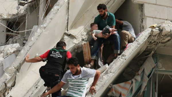 Syrian men remove a baby from the rubble of a destroyed building following a reported air strike in the Qatarji neighborhood of the northern city of Aleppo on September 21, 2016. (AFP/Ameer Alhalbi)