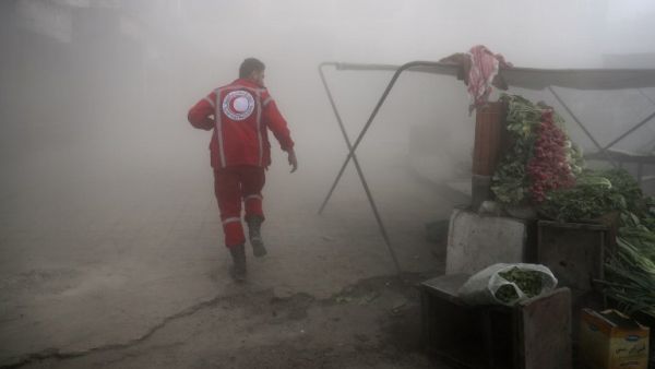 A member of the Syrian Arab Red Crescent searches for victims following a reported government airstrike on the rebel-held town of Douma, near Damascus, on November 10, 2016. (AFP/Abd Doumany)