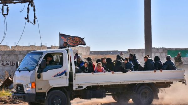 Displaced families arrive at a makeshift camp in a government-held area (George Ourfalian/AFP)