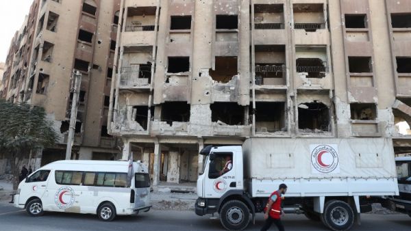A Syrian Arab Red Crescent lorries are seen in the rebel-held town of Douma, east of the Syrian capital Damascus, on October 19, 2016. (AFP/Abd Doumany)
