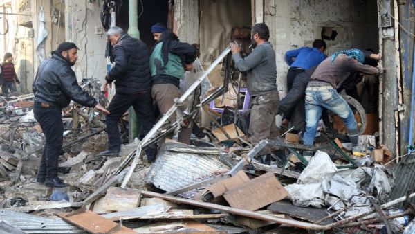 Syrian men search for survivors following an air strike on the village of Maaret al-Numan, in the country's northern province of Idlib, on December 4, 2016. (AFP/Mohamed al-Bakour)