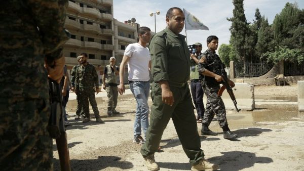 This file photo taken on April 30, 2016 shows Jowan Ibrahim (C), the commander of the Kurdish police (aka Asayish) arriving at a checkpoint where a suicide bomber killed five Kurdish policemen in Syria's divided northeastern city of Qamishli. (AFP/Delil Souleiman)