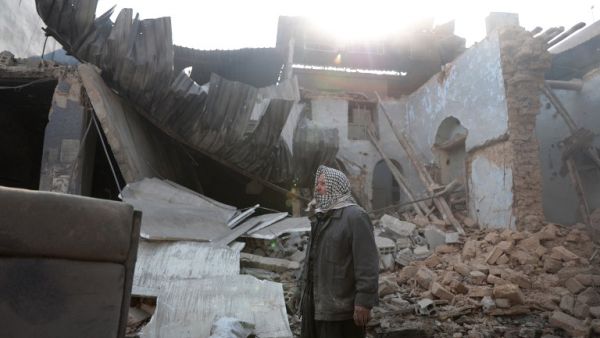 Syrian Abu Khaled stands amid the rubble of his destroyed house in the rebel-held town of Douma, on the eastern outskirts of Damascus, on December 30, 2016, on the first day of a nationwide truce. (AFP/Abd Doumany)