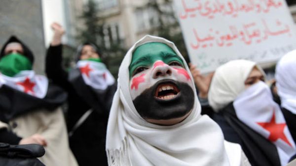 A young woman with her face painted with the Syrian flag attends a demonstration against Syrian President Bashar al-Assad in front of the Syrian Consulate on December 16, 2011 in Istanbul. (AFP/Bulent Kilic)
