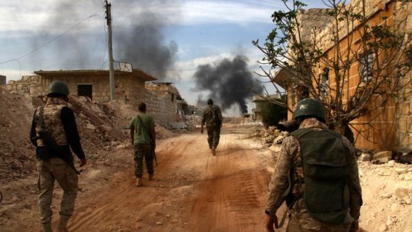Syrian government forces walk in the strategic area of the Bazo hilltop, north of Khan Tuman on the southern outskirts of the northern embattled Syrian city of Aleppo on October 25, 2016. (AFP/George Ourfalian)