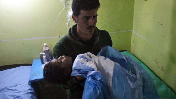 An unconscious Syrian child is carried at a hospital in Khan Sheikhun, a rebel-held town in the northwestern Syrian Idlib province, following a suspected toxic gas attack on April 4, 2017. (AFP/Omar Haj Kadour) An unconscious Syrian child is carried at a hospital in Khan Sheikhun, a rebel-held town in the northwestern Syrian Idlib province, following a suspected toxic gas attack on April 4, 2017. (AFP/Omar Haj Kadour)