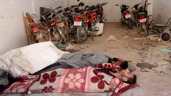 Bodies of those killed during a chemical attack in Syria's Idlib province lie in a storage room in a hospital in Khan Sheikhoun, 4 April 2017. (AFP/Omar Haj Kadour)