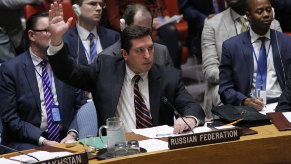 Russian Deputy Permanent Representative to the United Nations Vladimir Safronkov holds up his hand as he votes against a Draft resolution that condemns the reported use of chemical weapons in Syria at the Security Council on April 12, 2017 at UN Headquarters in New York. (AFP/Kena Betancur)