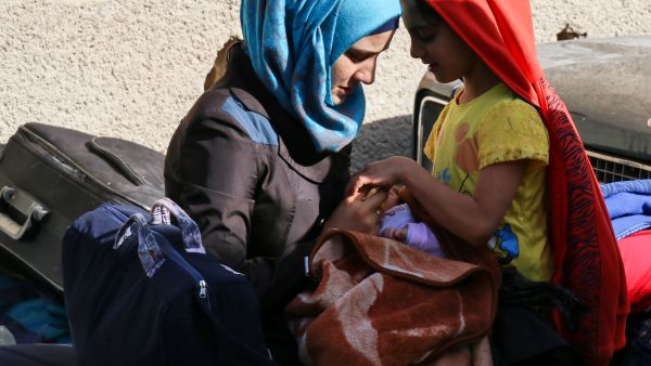 A Syrian woman and girl wait to be evacuated from opposition-held Barzeh, May 8 2017. (AFP/Sari Abu Zaid)