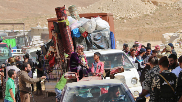 Lebanese security forces check identity and papers of Syrian refugees getting ready to cross into Syria from the eastern Lebanese border town of Arsal, Lebanon. (AFP)