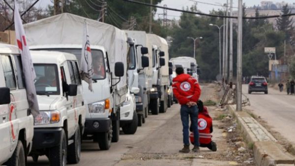 A convoy of aid from the International Committee of the Red Cross (ICRC) waits on the outskirts of the besieged rebel-held Syrian town of Madaya, on January 11, 2016. (AFP/Louai Beshara)