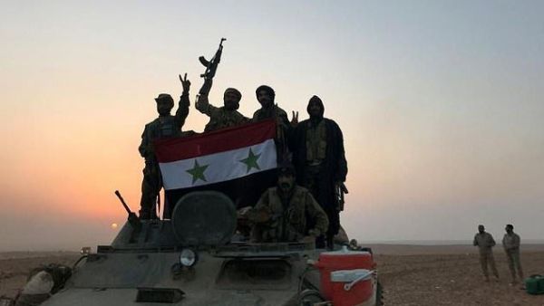Syrian forces celebrate victory in a village near al-Boukamal. (AFP/ File)