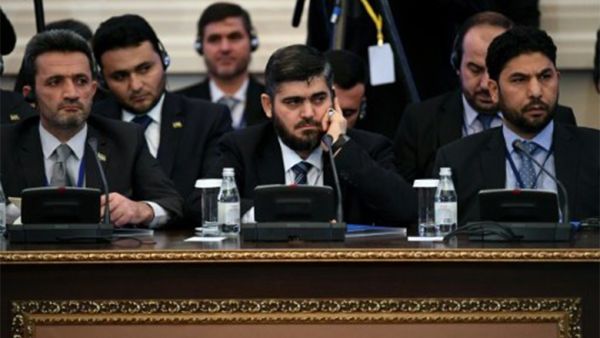Chief Syrian rebel negotiator Mohammad Alloush (C) of the Jaish al-Islam (Army of Islam) faction attends the first session of peace talks at Astana's Rixos President Hotel on January 23, 2017. (AFP)