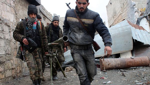 Opposition fighters carrying a rocket launcher during clashes against government forces in the northern Syrian city of Aleppo. (AFP/ File photo)