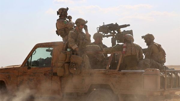 US special operations personnel ride in a pickup truck in the village of Fatisah in the northern Syrian province of Raqa on May 25, 2016 (AFP Photo/Delil Souleiman)