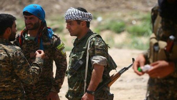 Members of the YPG and Syrian Democratic Forces in a distrcit of Raqqa on June 11. (AFP/Delil Souleiman)