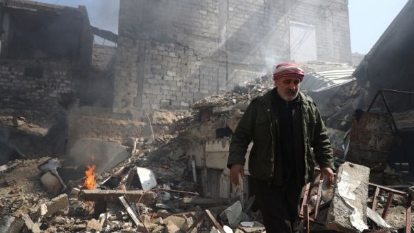 A Syrian man inspects the damage following reported government airstrike on the rebel-held town of Douma, on the eastern outskirts of the capital Damascus, on February 26, 2017. (AFP/Abd Doumany)
