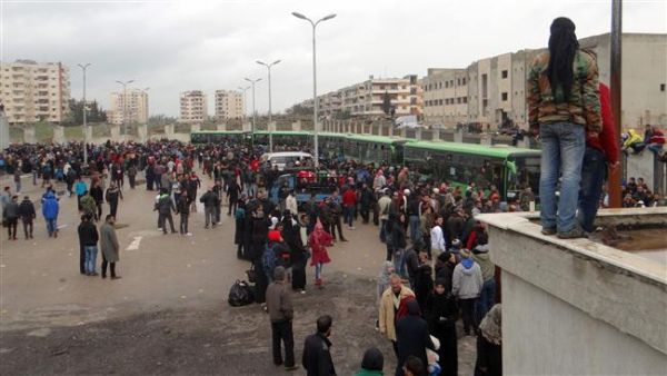 Militants and their families gather as they prepare to board a bus ahead of their evacuation from the al-Waer neighborhood of the Syrian city of Homs, March 18, 2017. (AFP/File) Militants and their families gather as they prepare to board a bus ahead of their evacuation from the al-Waer neighborhood of the Syrian city of Homs, March 18, 2017. (AFP/File)