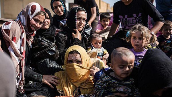 Syrian refugees from Raqqa governorate cross the Syria-Turkey border fleeing Isis in this file photo dated June 22 2015. (AFP)