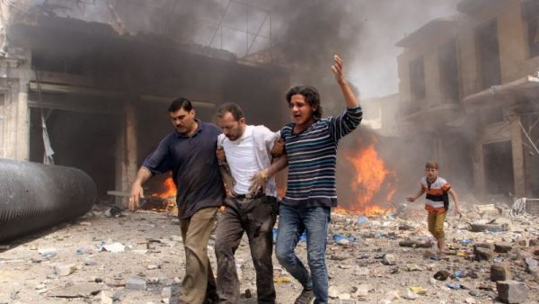 Walking through the destruction following a reported barrel bomb attack by Syrian government forces in the northern city of Aleppo. (AFP Photo/Karam al-Masri) 