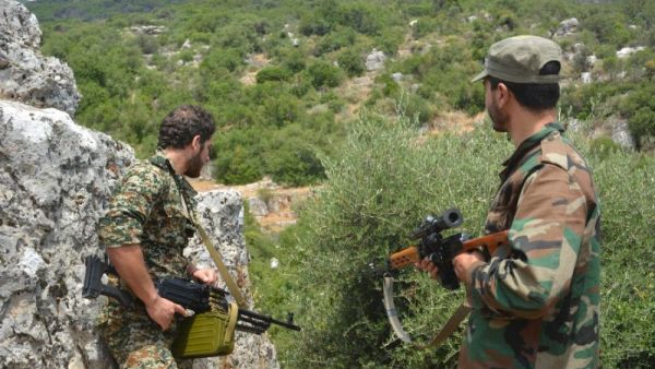Syrian pro-regime forces patrol in the Hama province, as families move back into the area. (AFP/File)