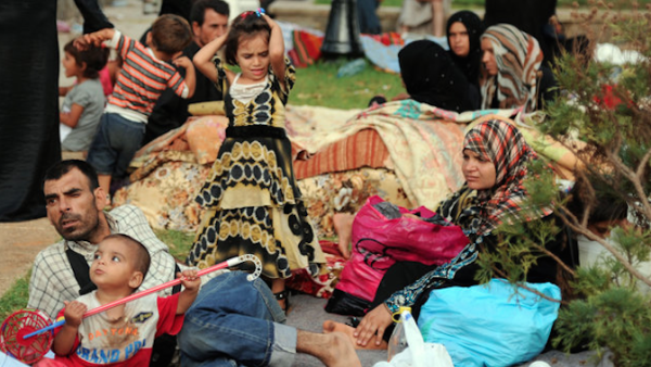 Syrian refugees wait in Port Said Square in Algiers, Algeria. (AFP/File)
