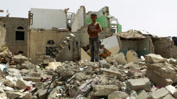 A child stands on a bombed building in Yemen. Around 6,000 people have been killed in Yemen since March (AFP)