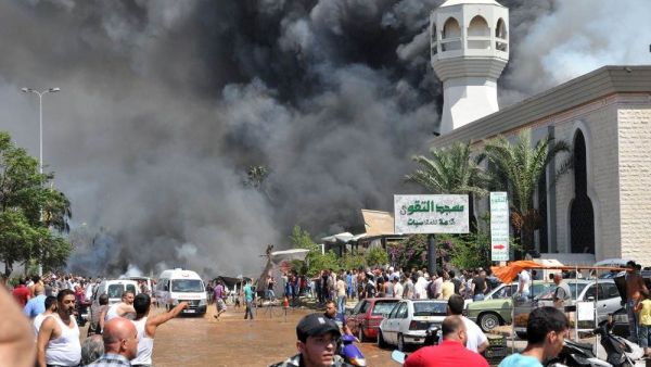 People run from the site of a bombing at a Tripoli mosque in 2013. (AFP/File)