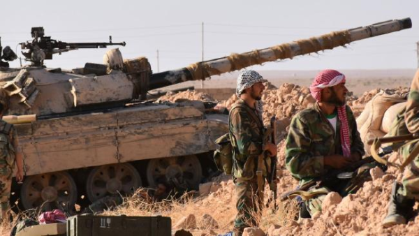 Regime-loyal militia soldiers overlooking a town near Deir Ezzour, AFP