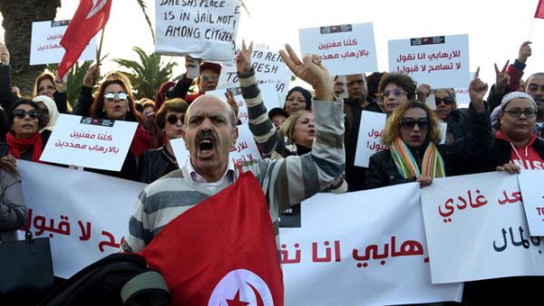 Tunisians shout slogans during a demonstration outside parliament in Tunis on Saturday against allowing Tunisians who joined the ranks of extremist groups to return to their country. (AFP/File)