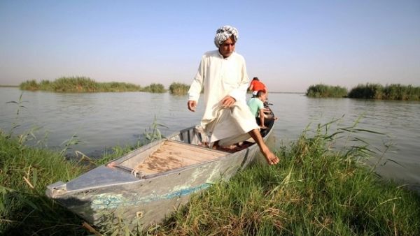 A "Marsh Arab" gets out of a boat in the al-Ahwar Marshlands in Iraq (AFP) A "Marsh Arab" gets out of a boat in the al-Ahwar Marshlands in Iraq (AFP)