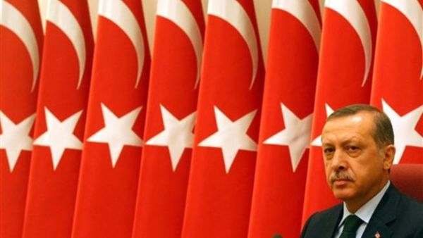 Turkish President Recep Tayyip Erdogan with Turkish flags in the background (AFP)